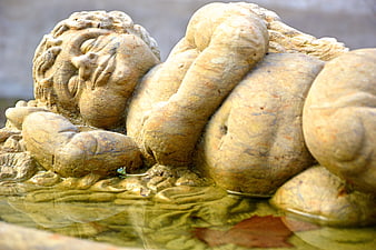 Weathered Stone Putto Sculpture Reclining in Water Feature