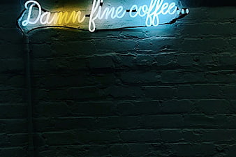 Damn Fine Coffee Neon Sign on Dark Brick Wall