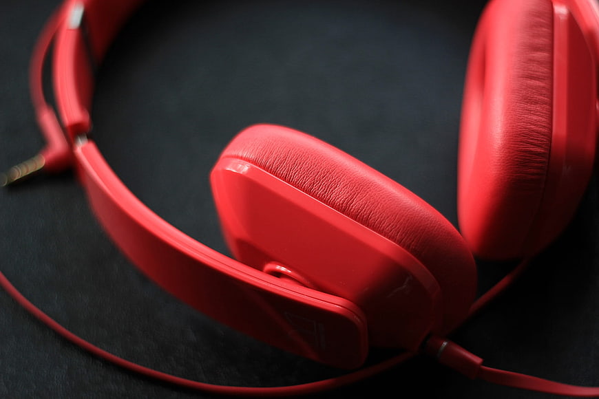 Close-up of red over-ear headphones on black background