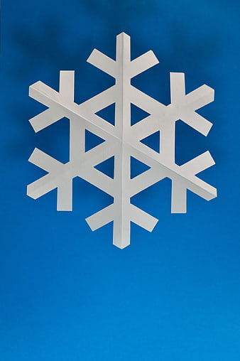 White Paper Snowflake on Blue Background
