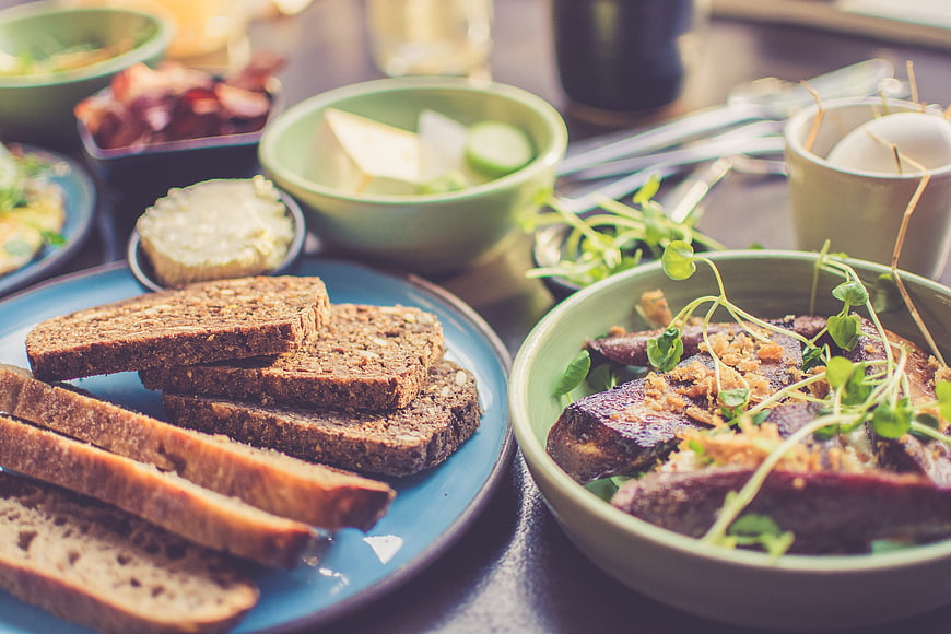 Healthy breakfast spread with whole grain bread and roasted vegetables