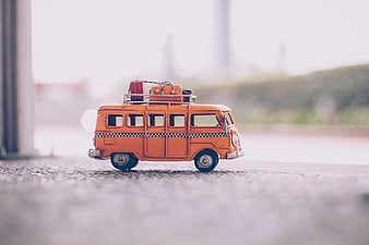 Orange Toy Bus with Luggage on Roof Rack