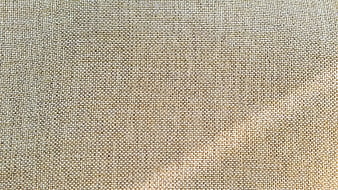 Close-up texture of beige woven jute fabric background