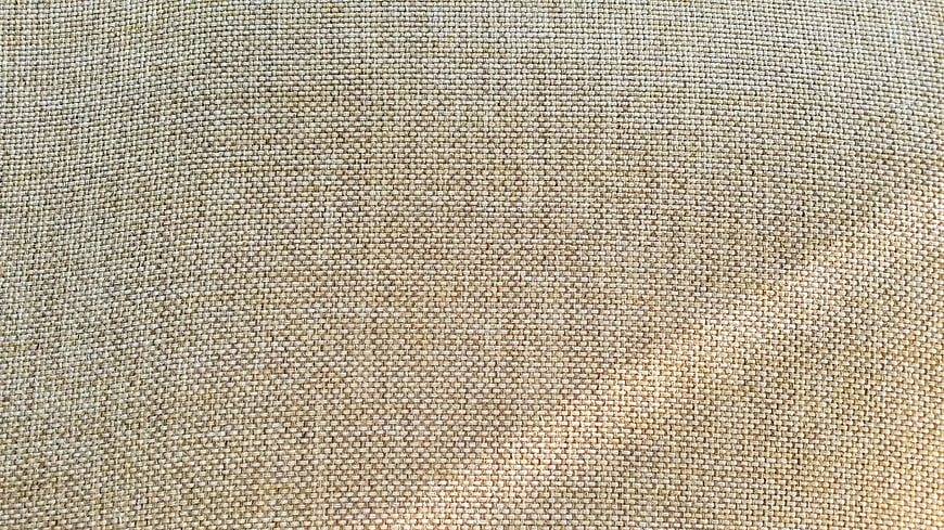 Close-up texture of beige woven jute fabric background