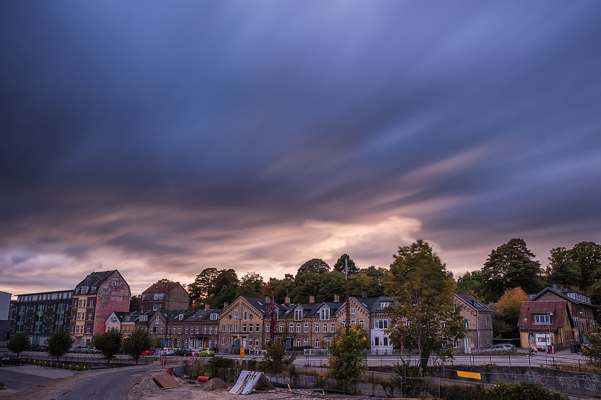 Dramatic Cloudy Sky Over Urban Residential Street at Dusk