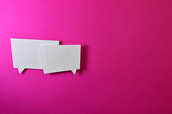 Two white paper speech bubbles on a vibrant magenta background