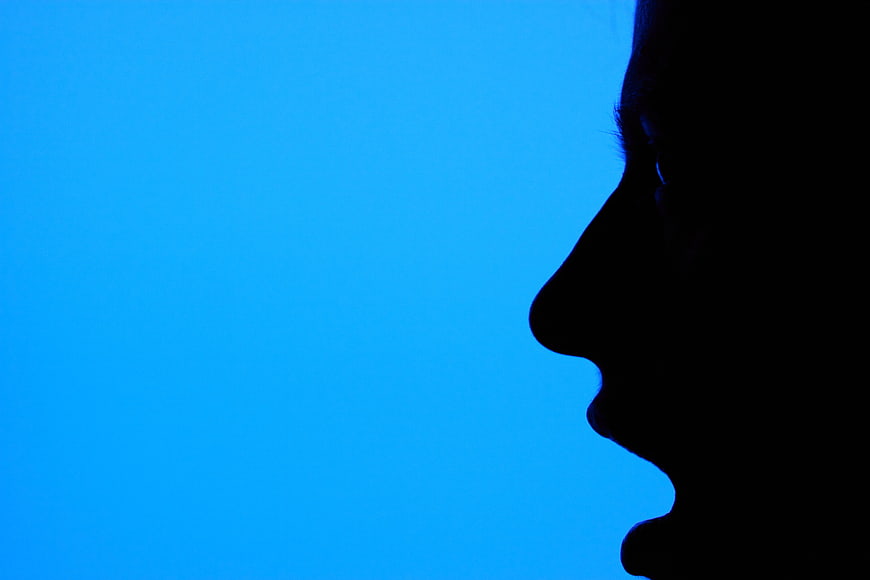 Woman Profile Silhouette Against Vibrant Blue Background
