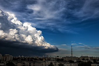 Dramatic Storm Clouds Over Urban Cityscape Skyline