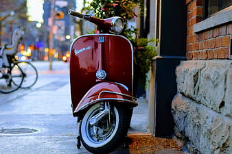 Vintage Red Vespa Scooter Parked on City Street
