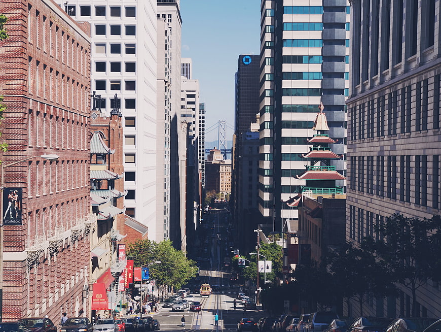 San Francisco Chinatown street view with pagoda and Bay Bridge