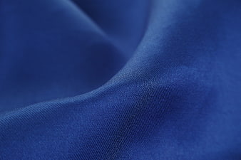 Close-up of textured blue fabric with soft folds