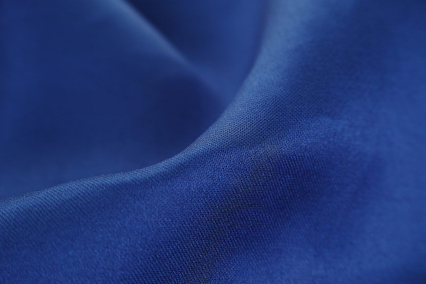Close-up of textured blue fabric with soft folds