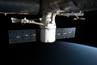 Spacecraft Docked with International Space Station Over Earth