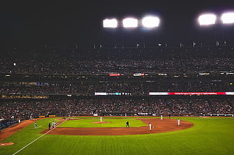 Night baseball game at AT&T Park stadium with bright lights and crowd
