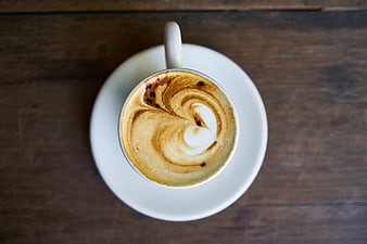 Top View of Cappuccino with Latte Art on Wooden Table