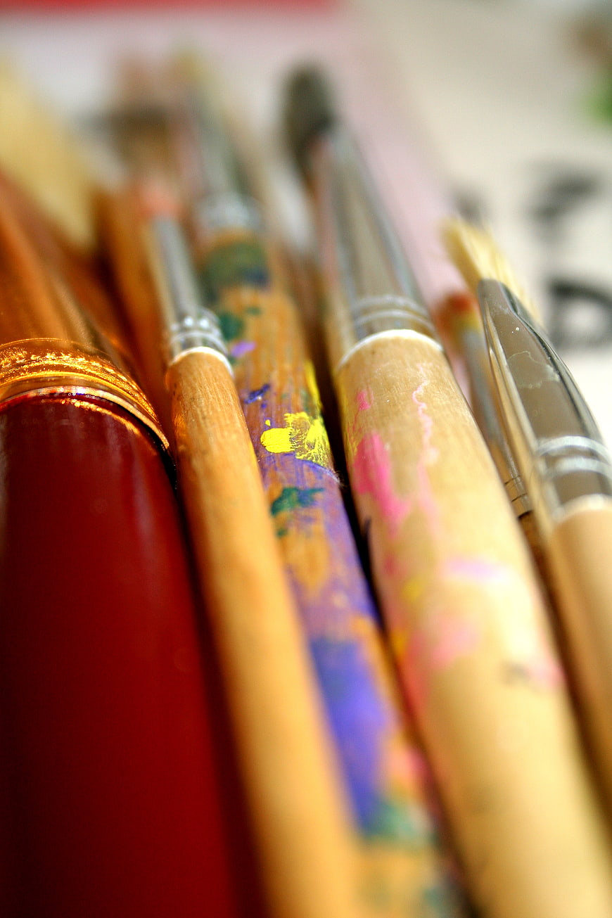 Close-up of colorful paint-stained artist brushes
