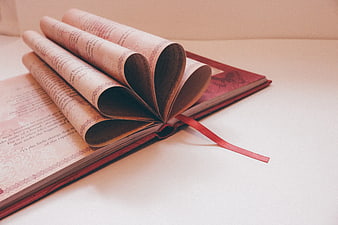Open Book with Heart-Shaped Pages on White Background