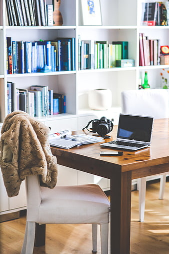 Cozy Home Office Desk with Laptop, Camera, and Books