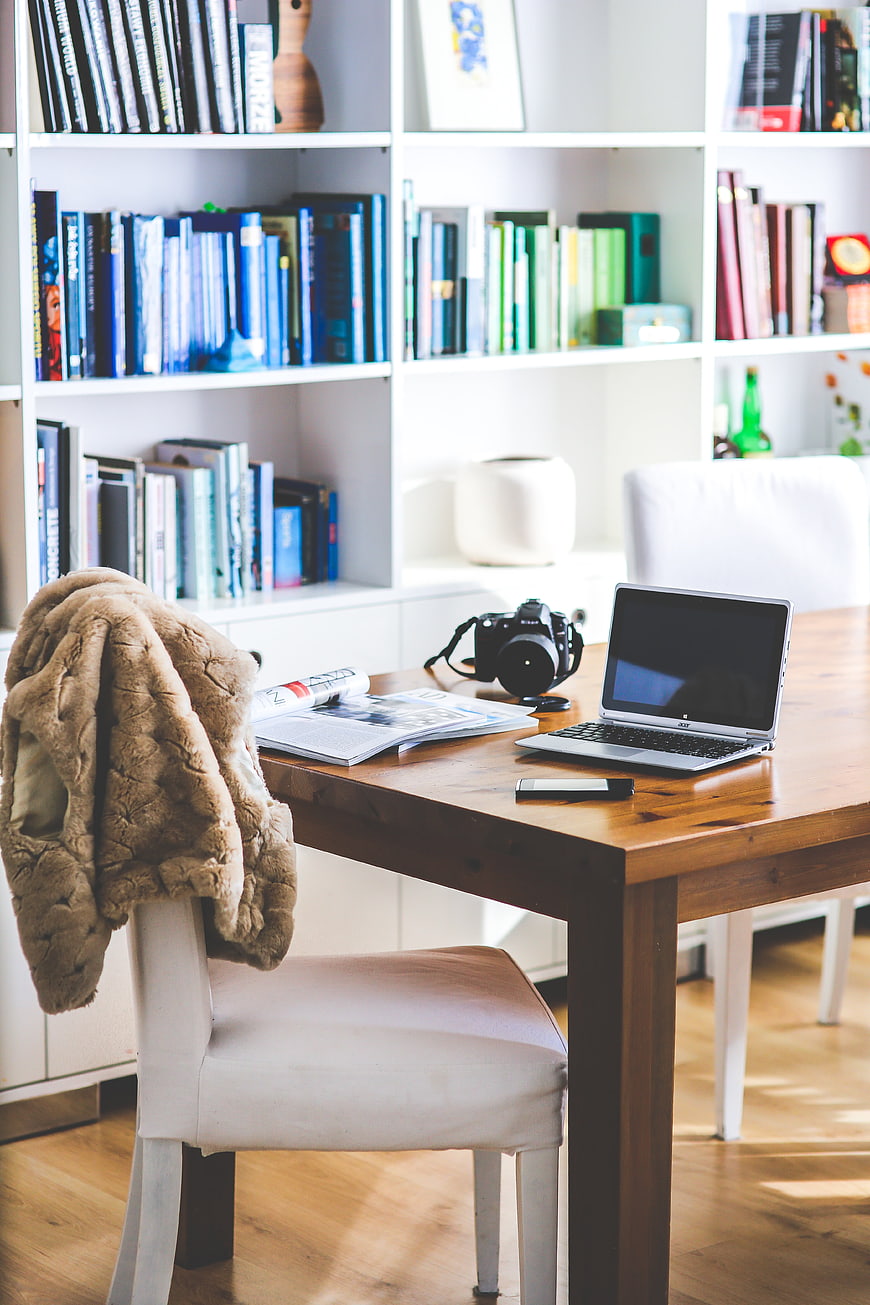 Cozy Home Office Desk with Laptop, Camera, and Books