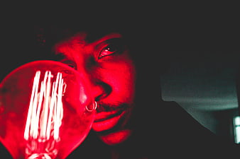 Man with Red Light Bulb in Dark Moody Portrait