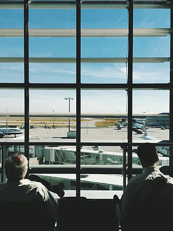 Two Men Waiting at Airport Terminal Window