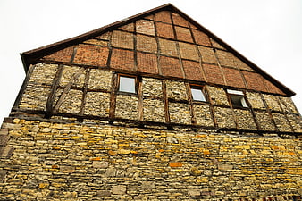 Low angle view of historic half-timbered stone building facade