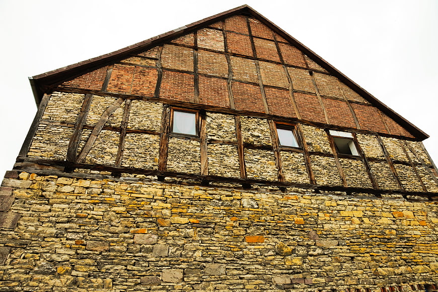 Low angle view of historic half-timbered stone building facade