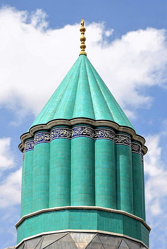 Green Tiled Minaret Dome With Arabic Calligraphy Against Blue Sky