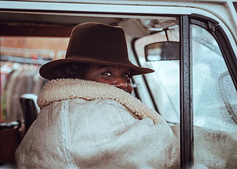 Woman in Hat Smiling from Vintage Car Interior