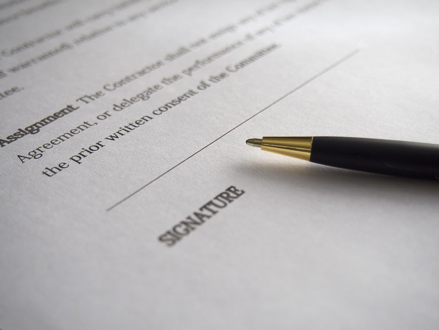 Pen on Contract Signature Line Close Up