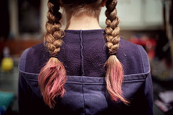 Back view of girl with pink-tipped braids in purple hoodie