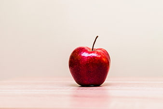 Single Red Apple on Wooden Table with Copyspace