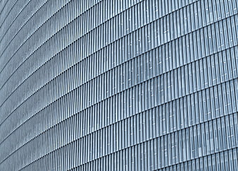 Modern Glass Building Facade with Diagonal Metal Louvers