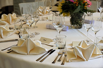 Elegant Formal Table Setting With White Linens And Floral Centerpiece