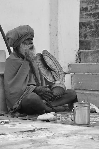Elderly Indian Sadhu Monk Sitting on Street Steps