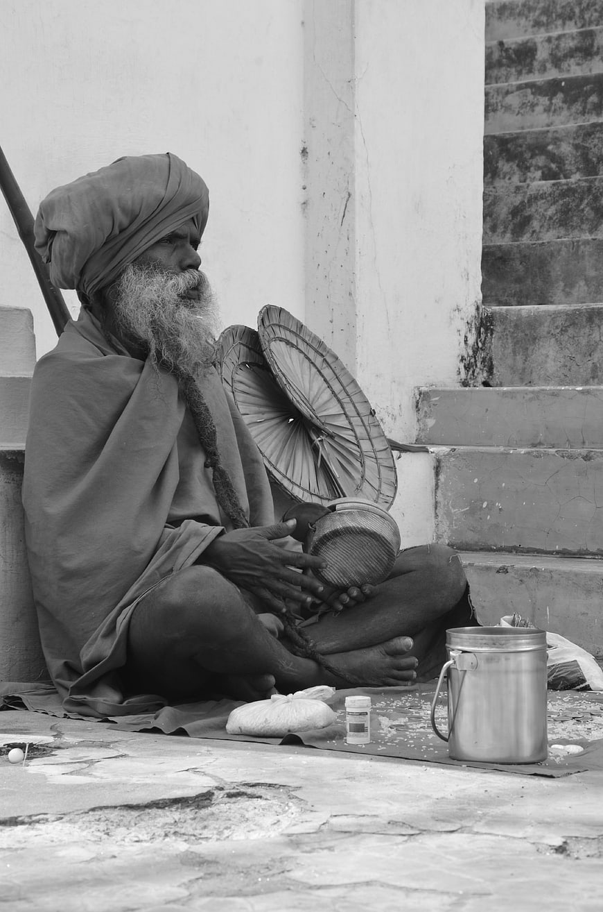 Elderly Indian Sadhu Monk Sitting on Street Steps
