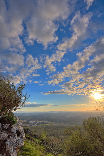 Scenic mountain sunset with dramatic clouds and valley view