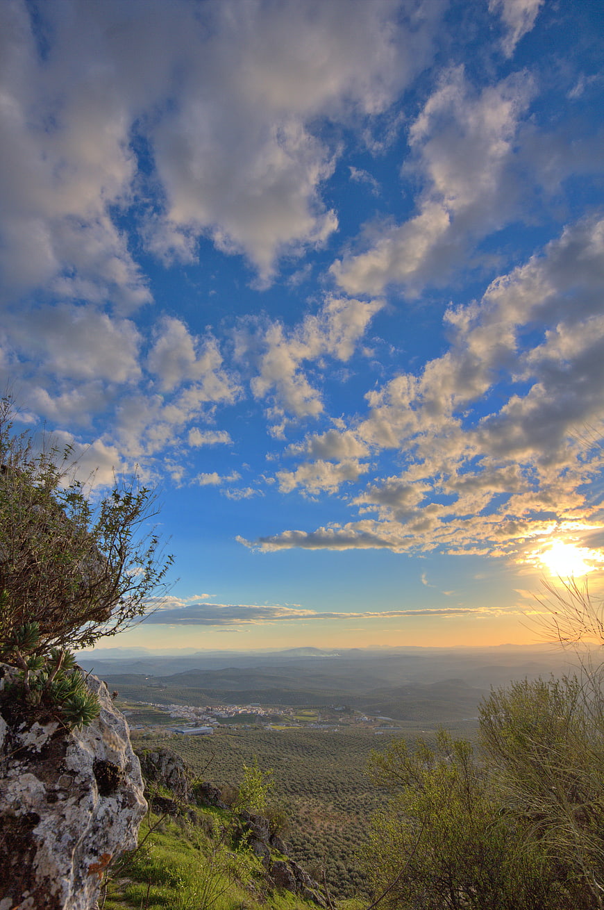Scenic mountain sunset with dramatic clouds and valley view