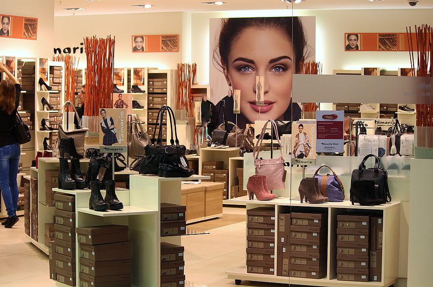 Interior of a Tamaris shoe store with bags and displays