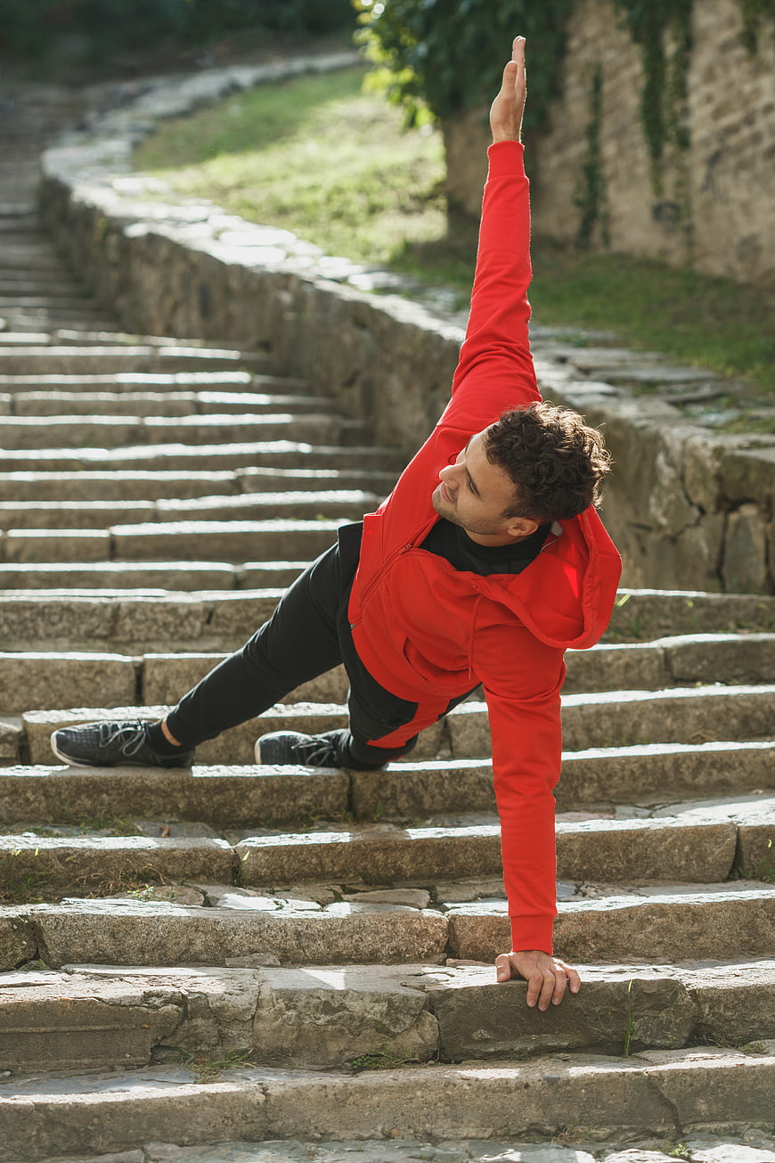 Man stretching on stone steps outdoors