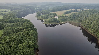 Aerial View of Serene River Bend with Forest and House