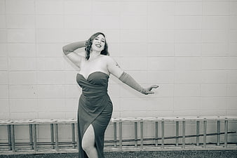 Vintage style woman in elegant dress and gloves posing