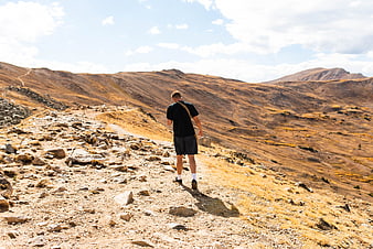 Man hiking on rocky mountain trail in Colorado