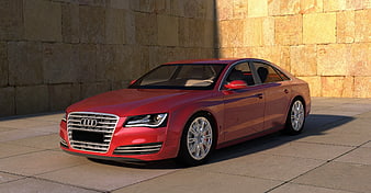 Red Audi A8 luxury sedan parked against stone wall