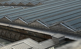 Aerial view of industrial glass roof with metal framework and brick walls