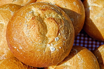 Close-up of fresh golden bread rolls with flour dust