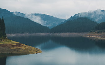 Serene Mountain Lake with Misty Forest Reflections