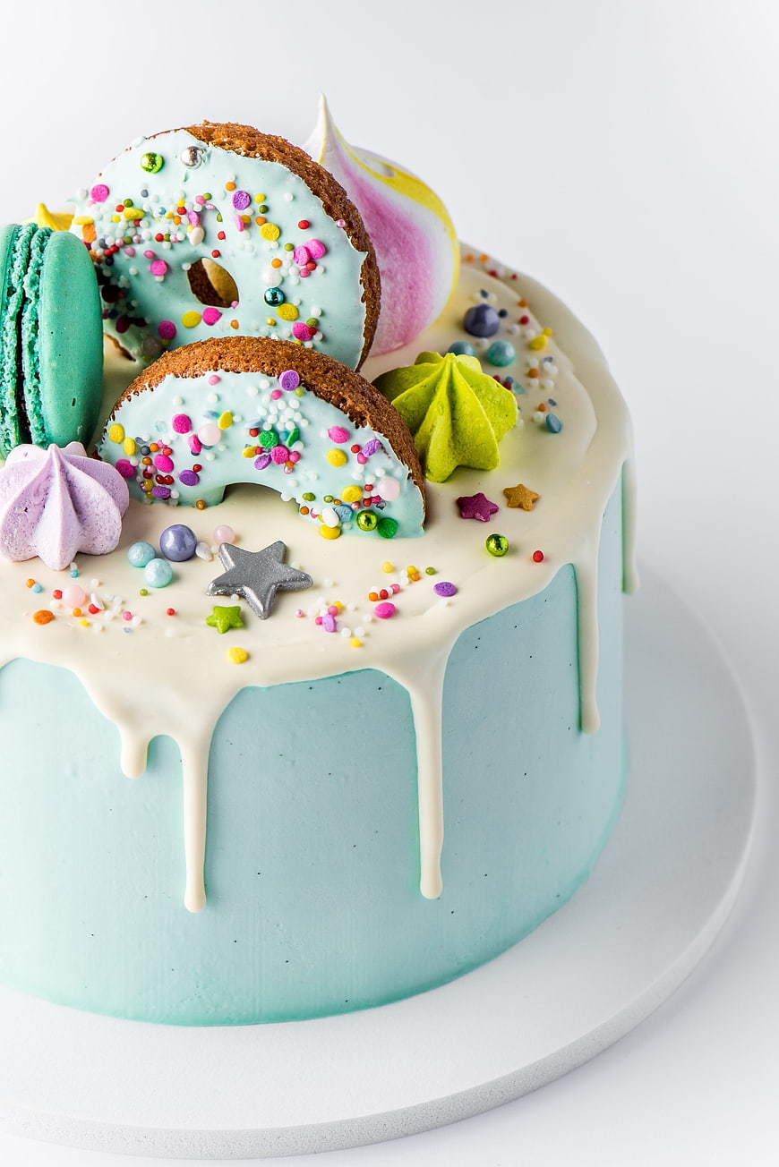 Colorful Birthday Cake With Sprinkles, Macarons, And Pastel Frosting
