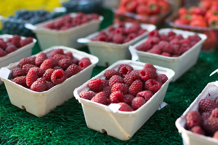 Fresh Raspberries in Cardboard Containers at Farmers Market