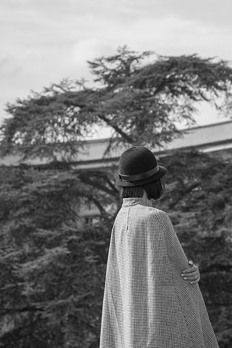 Woman in Fedora and Checkered Cape Back View
